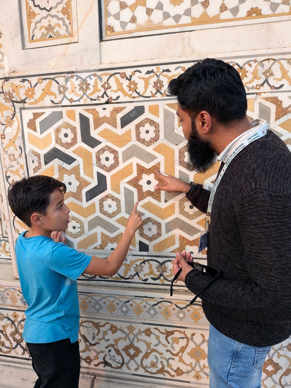 Explaining Mughal inlay art to a young traveller at Baby Taj in Agra